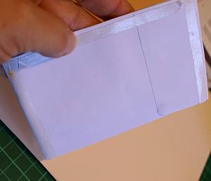 Adhere along the top and the sides of the envelop pockets