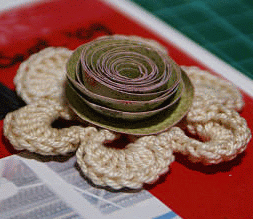 Spiral rose - cardstock spiralled on top of a cotton doiley