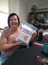 Shirley holding up a large bag of about 50 mixed cards for packing